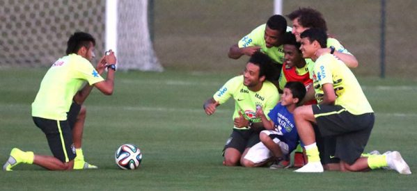 Neymar helps a pitch invader kid meeting the Brazilian Team